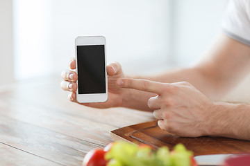 Image showing close up of male hands holding smartphone