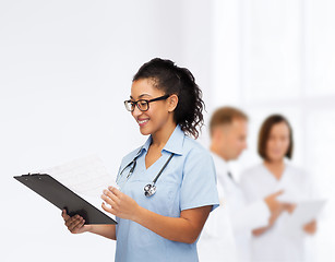 Image showing smiling female african american doctor or nurse