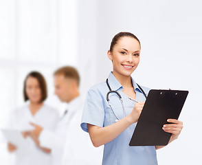 Image showing smiling female doctor or nurse with stethoscope