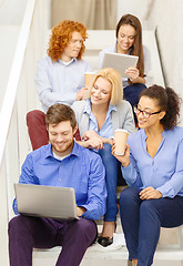 Image showing team with laptop and tablet pc on staircase