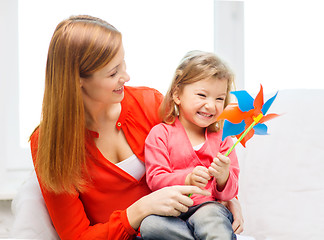 Image showing happy mother and daughter with pinwheel toy