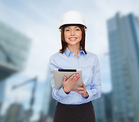 Image showing young smiling businesswoman in white helmet