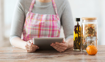 Image showing closeup of woman reading recipe from tablet pc