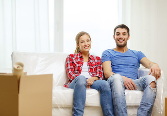 Image showing smiling couple relaxing on sofa in new home