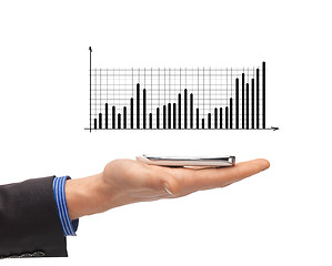 Image showing close up of man hand with smartphone and chart