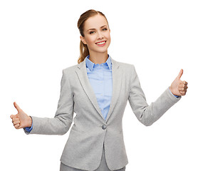 Image showing smiling businesswoman showing thumbs up