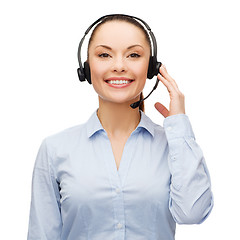 Image showing friendly female helpline operator with headphones