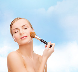 Image showing beautiful woman with makeup brush