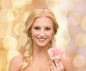 Image showing smiling woman with peony flower