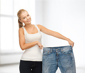 Image showing sporty woman showing big pants