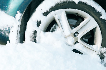 Image showing closeup of car wheel stuck in snow