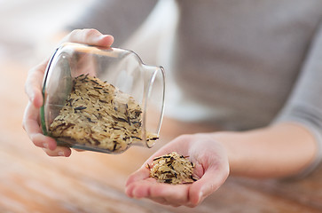 Image showing female emptying jar with white and wild black rice