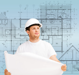 Image showing male architect looking at blueprint