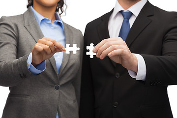 Image showing businessman and businesswoman with puzzle pieces