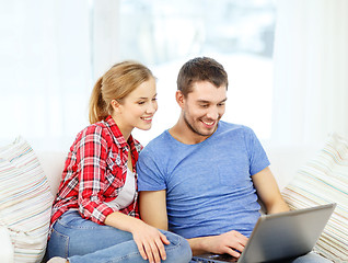 Image showing smiling couple with laptop computer at home