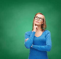 Image showing happy woman in black eyeglasses dreaming