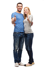 Image showing smiling couple showing thumbs up