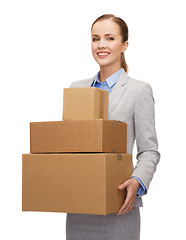 Image showing smiling businesswoman holding cardboard boxes