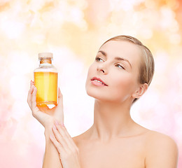 Image showing lovely woman with oil bottle