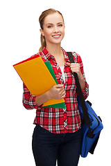 Image showing smiling female student with bag and folders