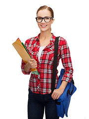 Image showing female student in eyeglasses with bag and folders