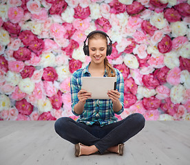 Image showing young woman in casual clothes sitting on floor