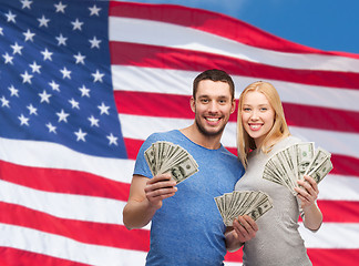 Image showing smiling couple holding dollar cash money