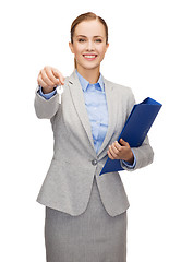 Image showing smiling businesswoman with folder and keys