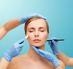 Image showing woman face and beautician hands with pencil