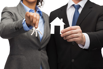 Image showing businessman and businesswoman holding white house