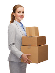 Image showing smiling businesswoman holding cardboard boxes