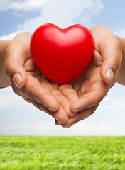 Image showing womans cupped hands showing red heart