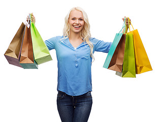Image showing smiling woman with many shopping bags