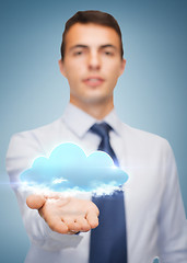 Image showing friendly buisnessman showing cloud on the palm