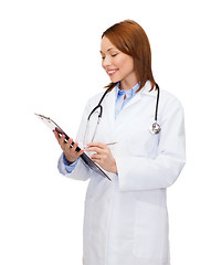 Image showing smiling female doctor with clipboard