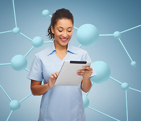 Image showing smiling black doctor or nurse with tablet pc