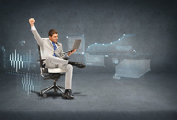 Image showing young businessman sitting in chair with laptop