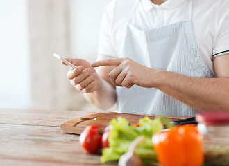 Image showing closeup of man pointing finger to smartphone