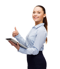 Image showing smiling woman looking at tablet pc computer