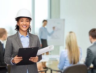 Image showing businesswoman in white helmet with clipboard