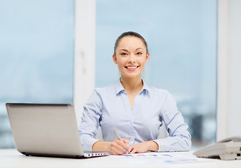 Image showing businesswoman with phone, laptop and files