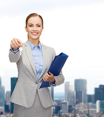 Image showing smiling businesswoman with folder and keys