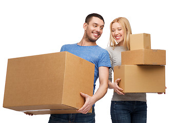 Image showing smiling couple holding cardboard boxes