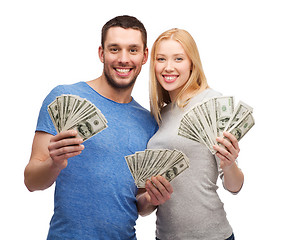 Image showing smiling couple holding dollar cash money