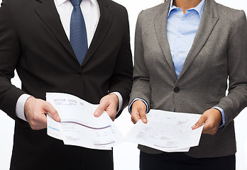 Image showing businesswoman and businessman with files and forms