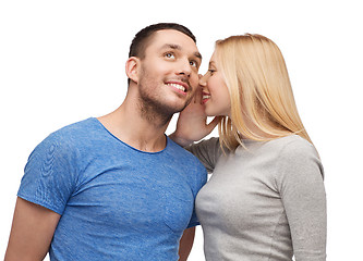 Image showing smiling girlfriend telling boyfriend secret