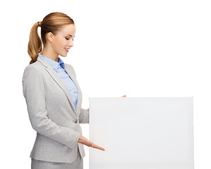 Image showing smiling businesswoman with white blank board