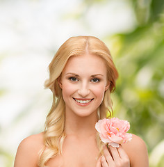 Image showing smiling woman with peony flower