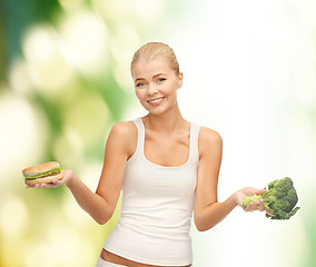 Image showing woman with broccoli and hamburger