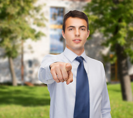 Image showing friendly young buisnessman pointing finger